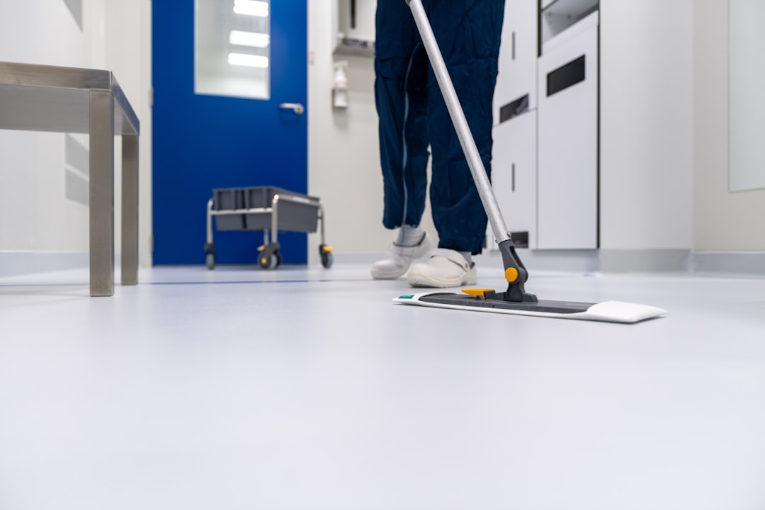A cleaner is cleaning the floor in a laboratory setting